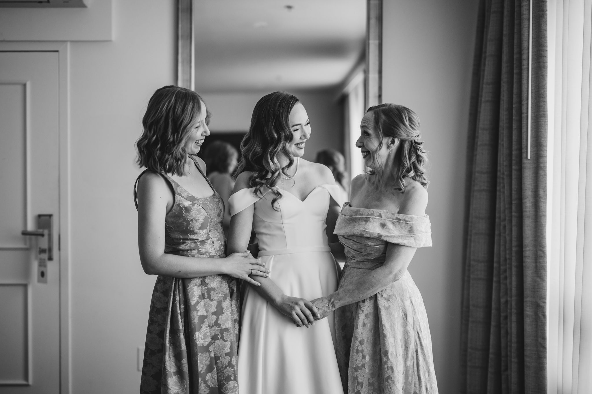 An elegant white wedding gown flowing gracefully near a window with soft natural light.