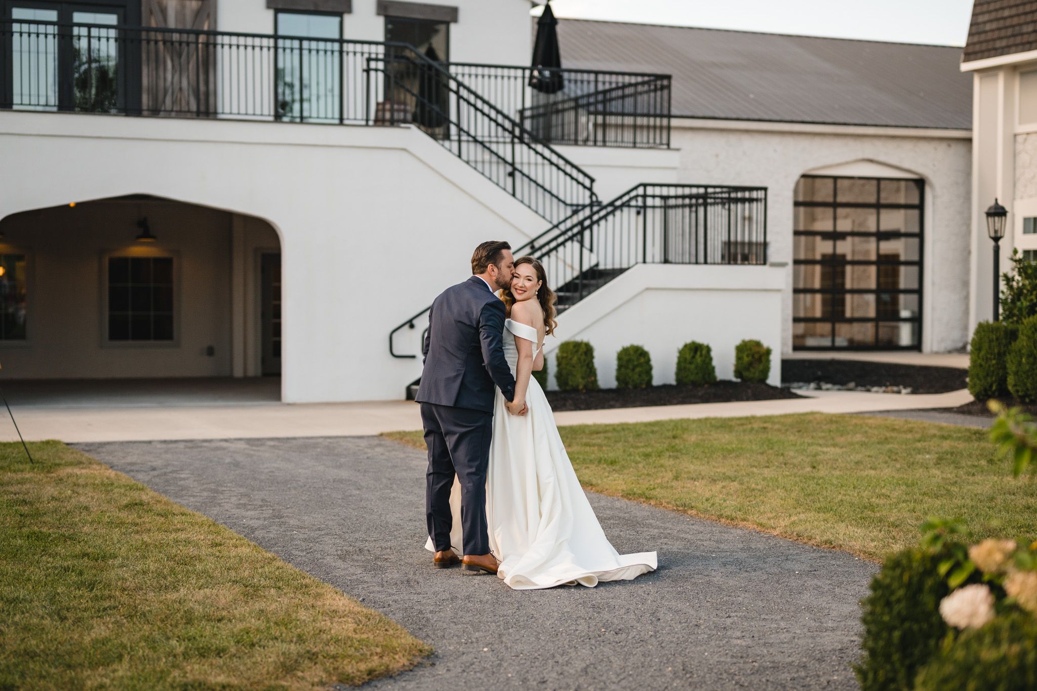 Wedding venue exterior with elegant stone walkway and architectural details.