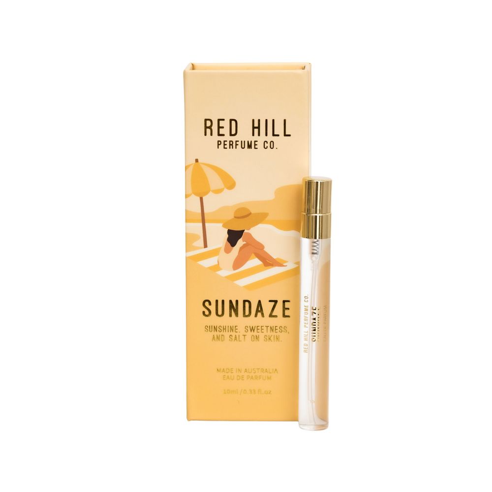Three perfume bottles displayed alongside packaging with 'Red Hill' and 'Sundaze' branding against a white background.
