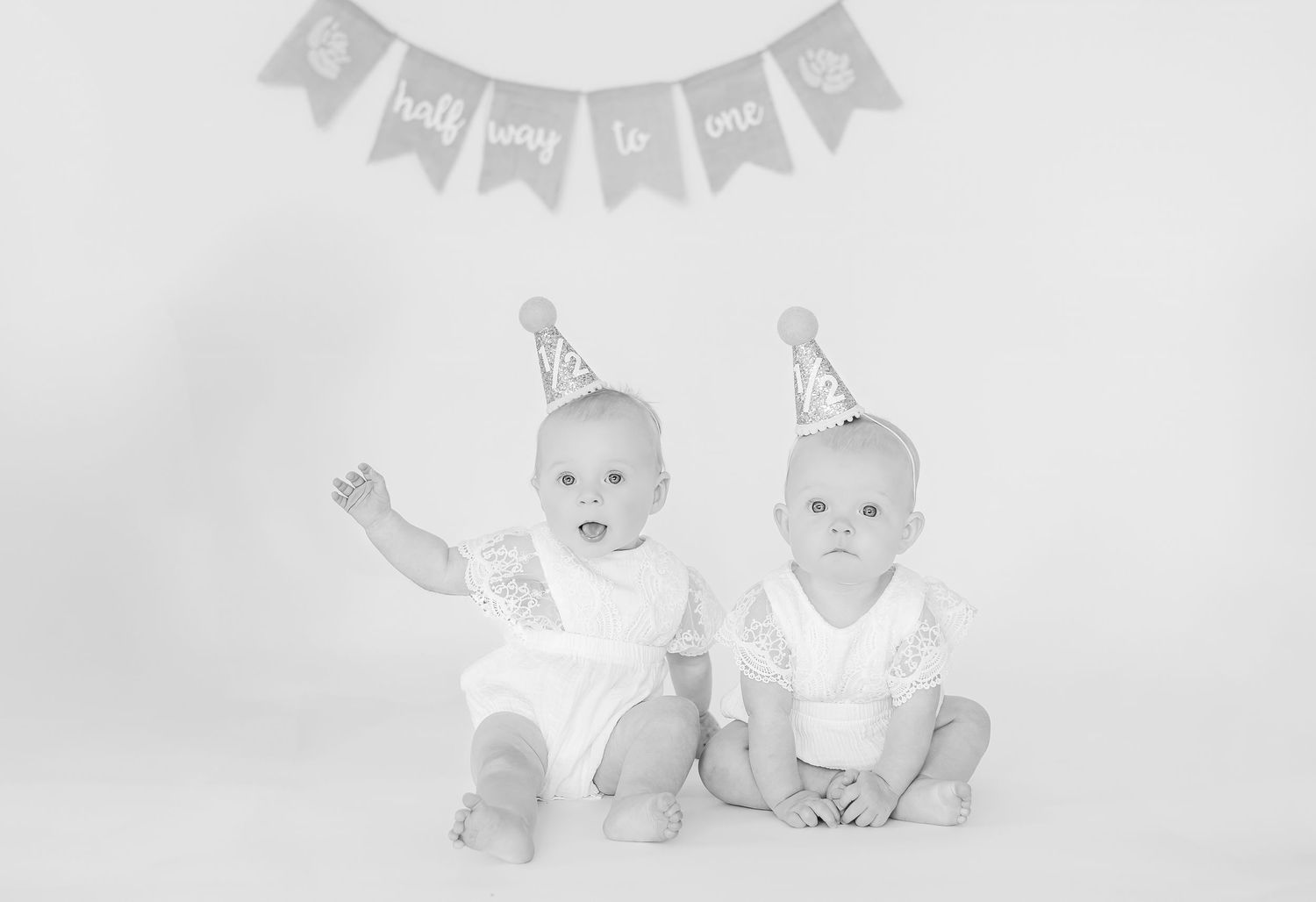 Minimalist gray and white baby milestone celebration banner and decorations.