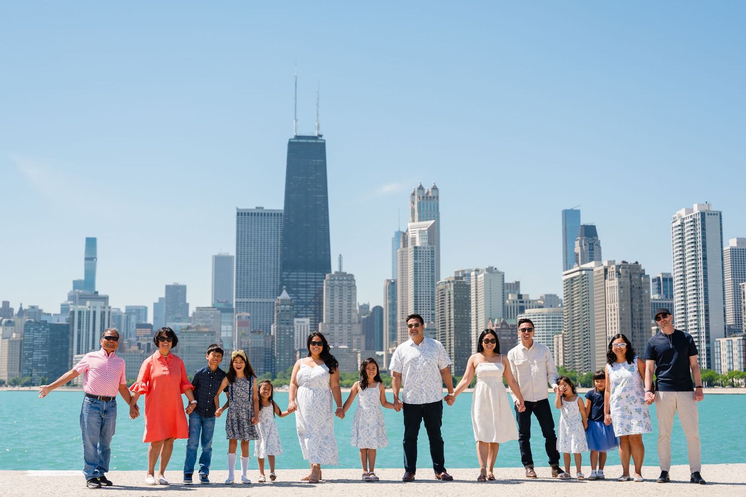 A family gather along Chicago's lakefront with the iconic skyline and Lake Michigan in the background.