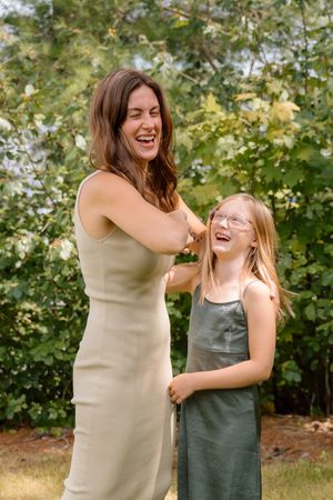 Candid sequence of joyful laughter and interaction outdoors with greenery in background.