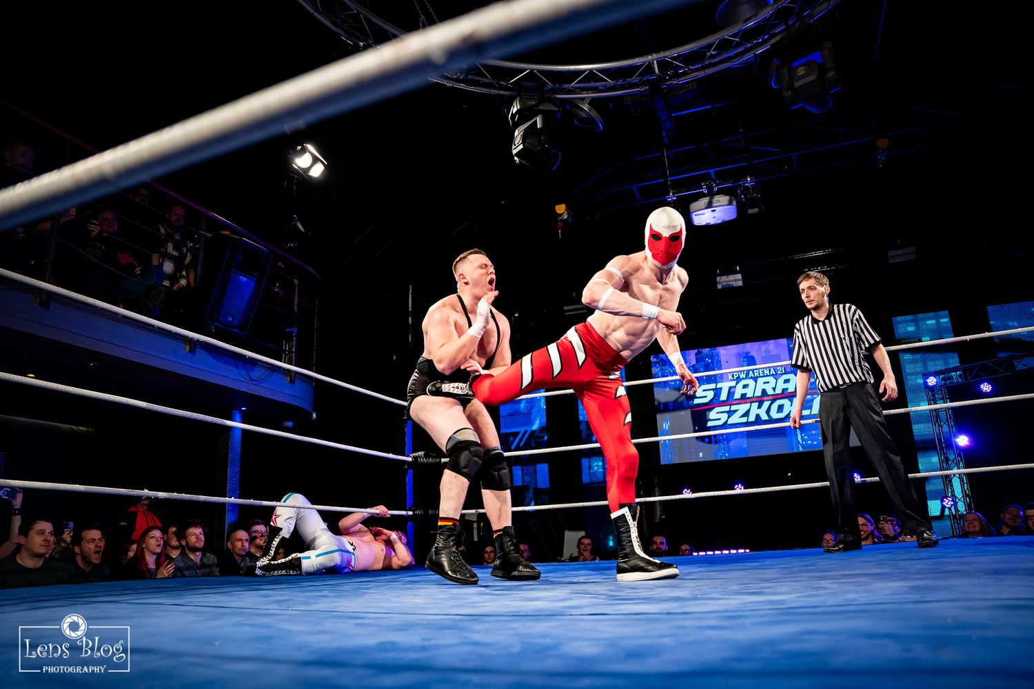 Wrestling action shots in blue-lit arena with competitors performing moves.