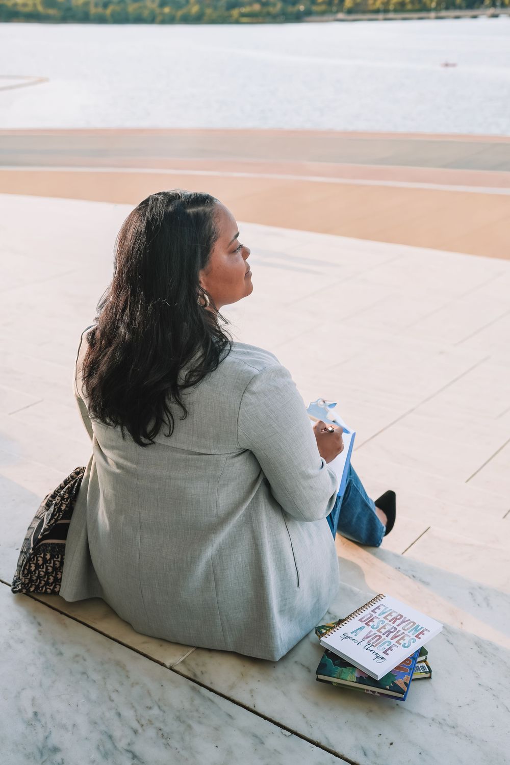 Professional headshot on concrete steps with books and backpack | Northern Virginia graduation portraits