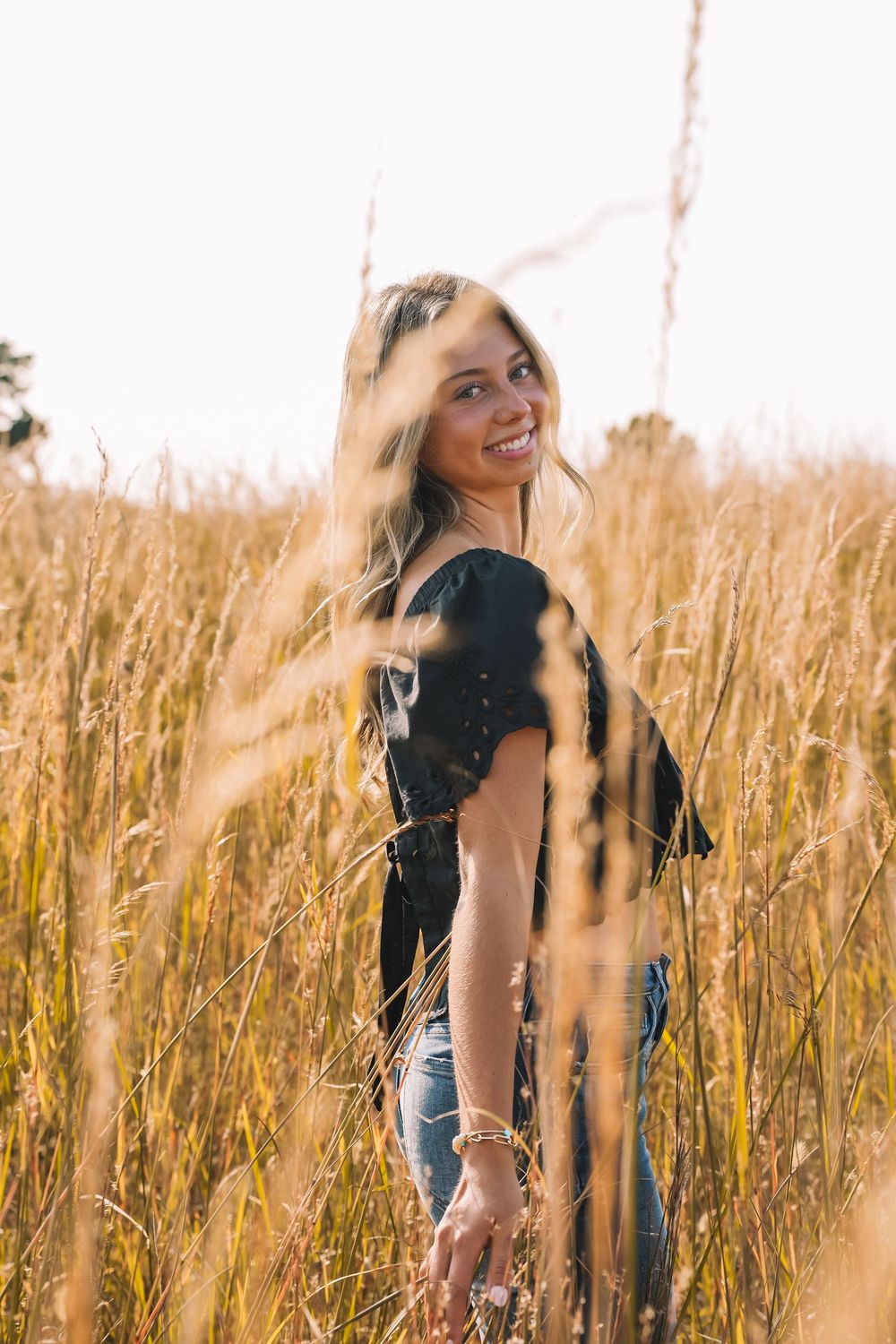 Joyful portrait in black top among golden wheat at sunset | Virginia photographer