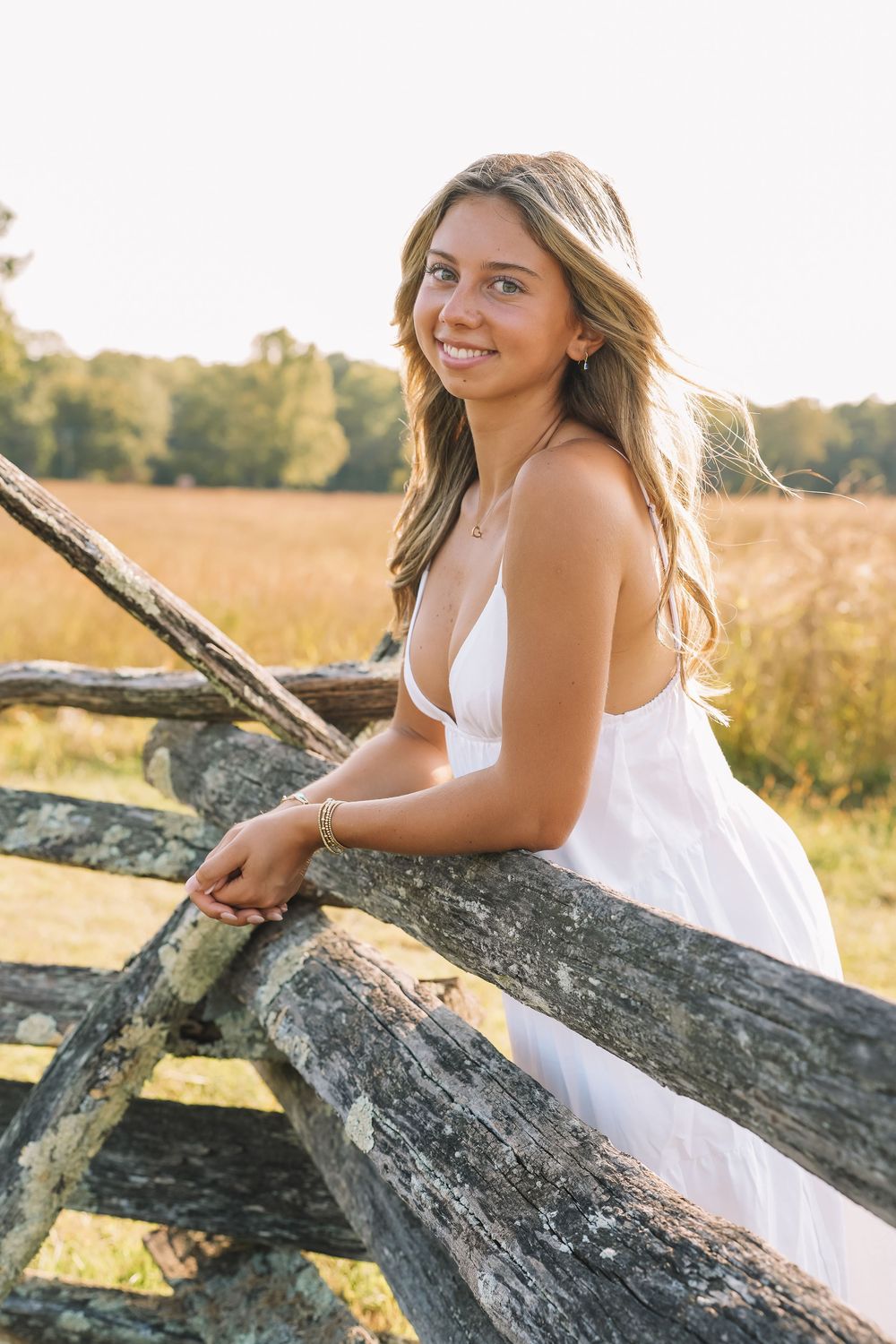 White dress portrait on rustic fence in golden field at sunset | NOVA portraits