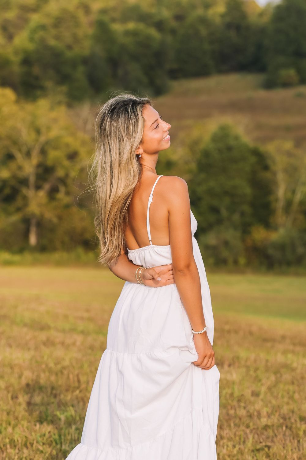 White sundress twirl in sunlit meadow at golden hour | Virginia lifestyle portraits
