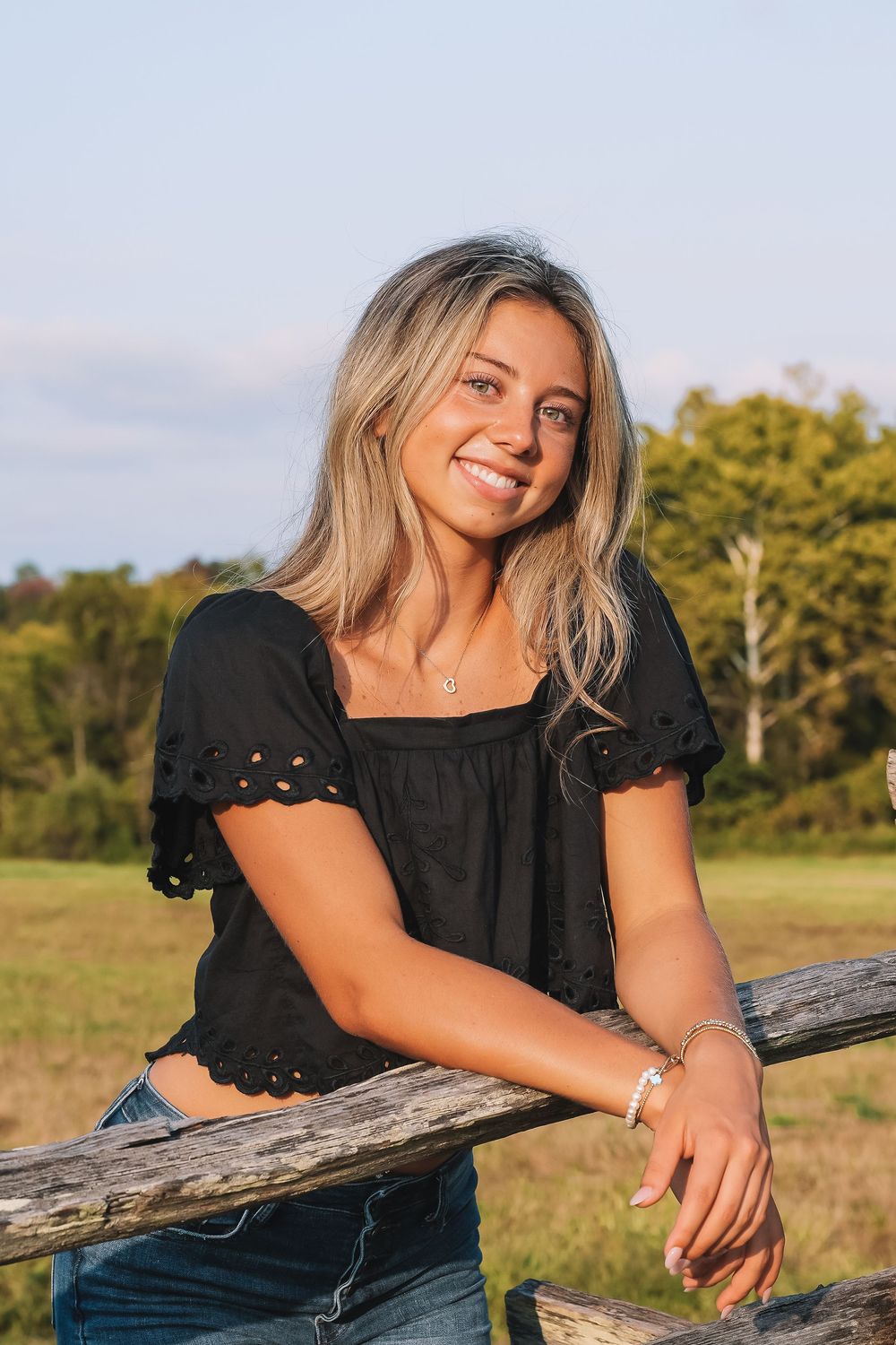 Summer portrait leaning on weathered fencing at dusk | Virginia portrait photographer