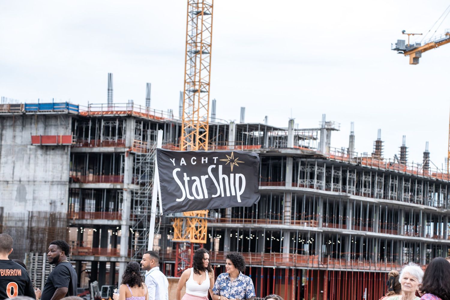 A construction site with multiple cranes and buildings under development in a cityscape.
