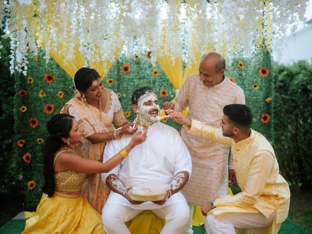 Traditional Indian Haldi ceremony celebration with yellow decor and floral backdrop during pre-wedding festivities.  Hilton Pearl River NY