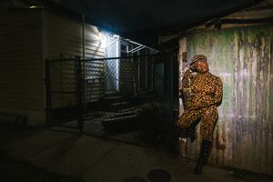 A dimly lit urban alleyway with graffiti walls and mysterious shadows creating an eerie atmosphere.