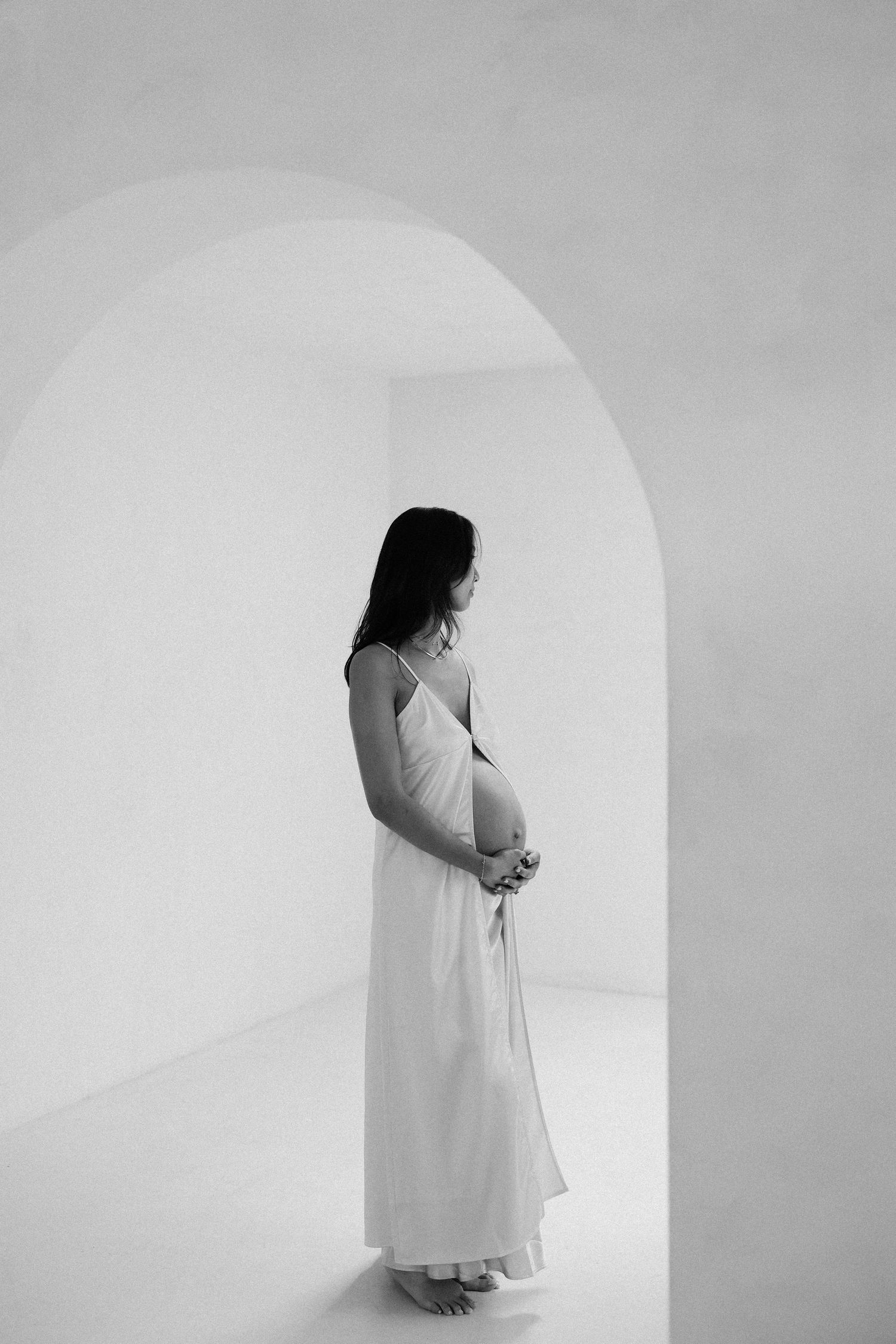 Elegant maternity photography session with neutral studio tones