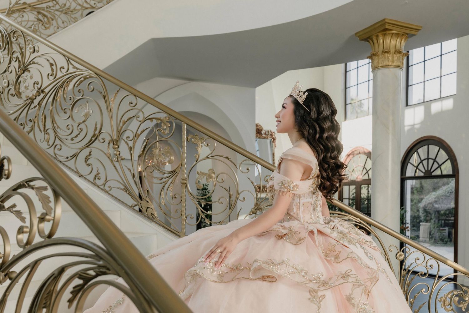Ornate palace interior with baroque style decorations featuring elegant white and gold architectural details.