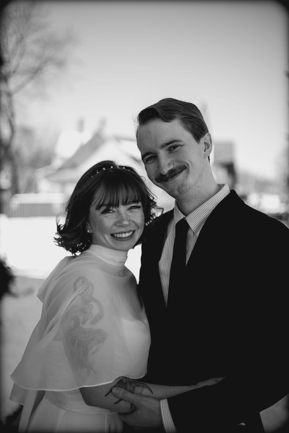 A romantic black and white photo sequence shows a couple embracing in winter, creating an intimate series of moments.