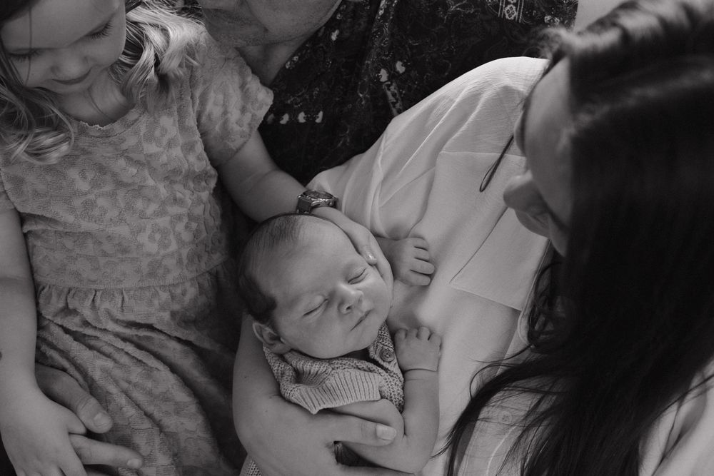 Black and white close-up photos showing tender family moments.