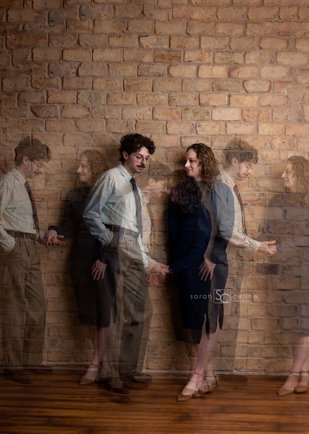 Artistic portrait against brick wall with shadows creating ghostly silhouettes in vintage style clothing.