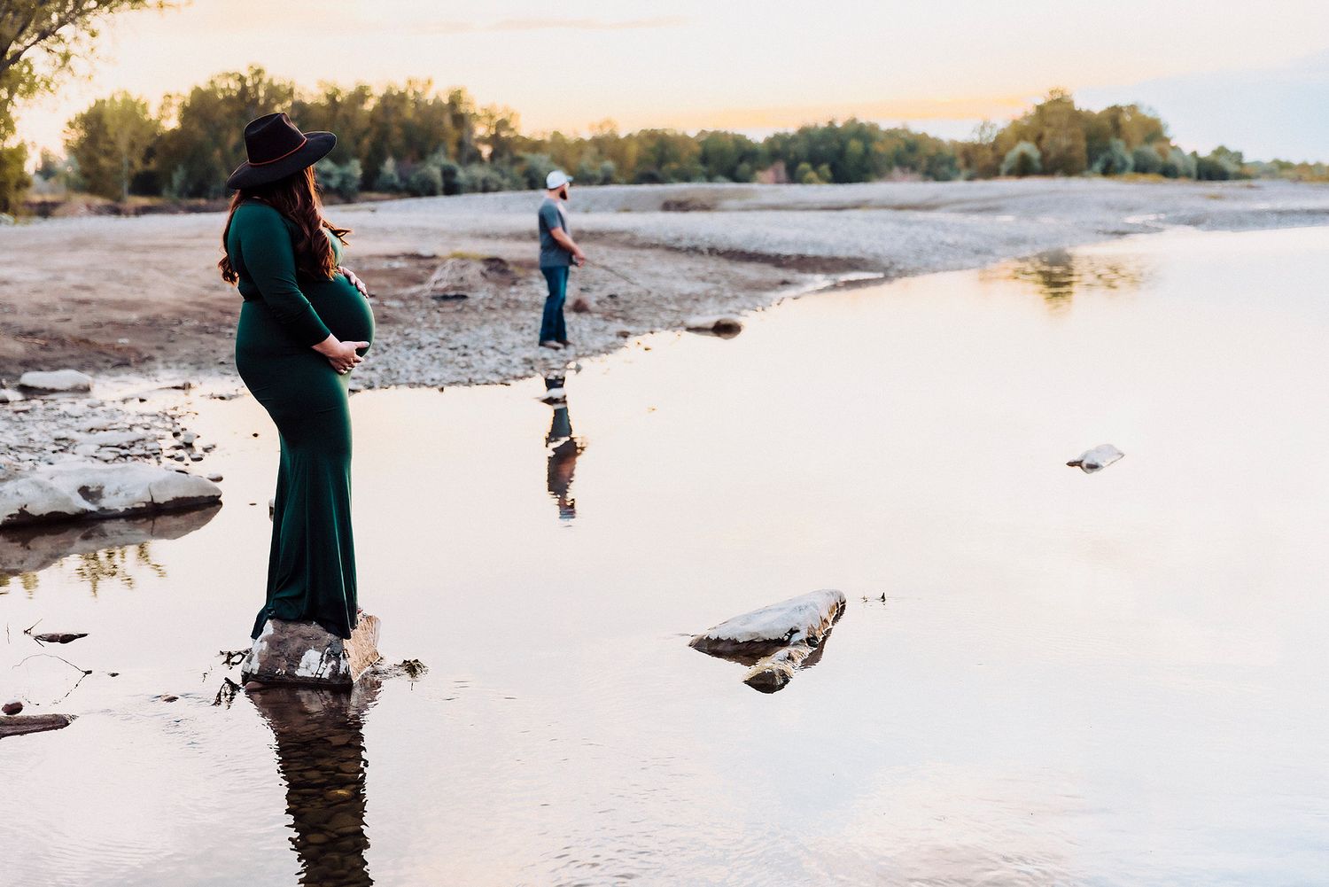 Vanessa Phillips Photo - Billings, MT Photographer - a maternity photo of a mom to be lookin on as dad is fishing on the Yellowstone River.