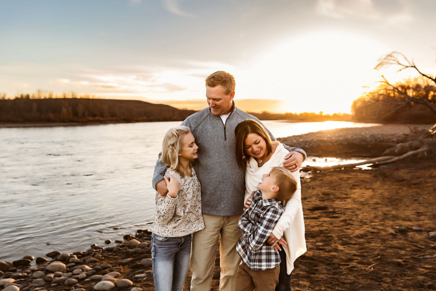 Vanessa Phillips Photo - Billings, MT Photographer - a mom, dad, daughter, and son in a family photo smiling at each other.