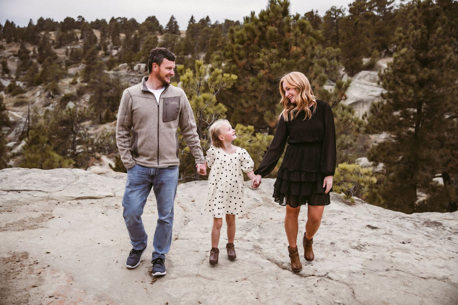 Vanessa Phillips Photo - Billings, MT Photographer - a mom, dad, and daughter, walking and looking at each other.
