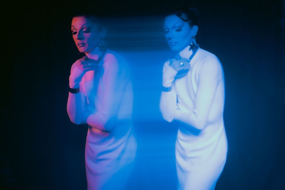 Dance performance with blue lighting effects creating ethereal atmosphere.