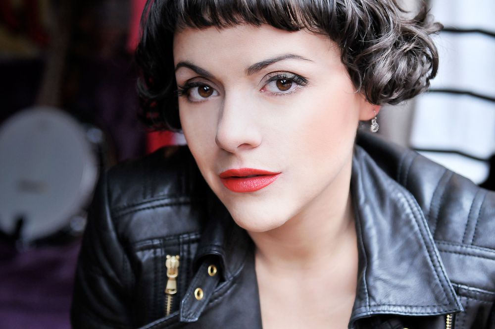 Retro-styled portrait with bold red lipstick and leather jacket.