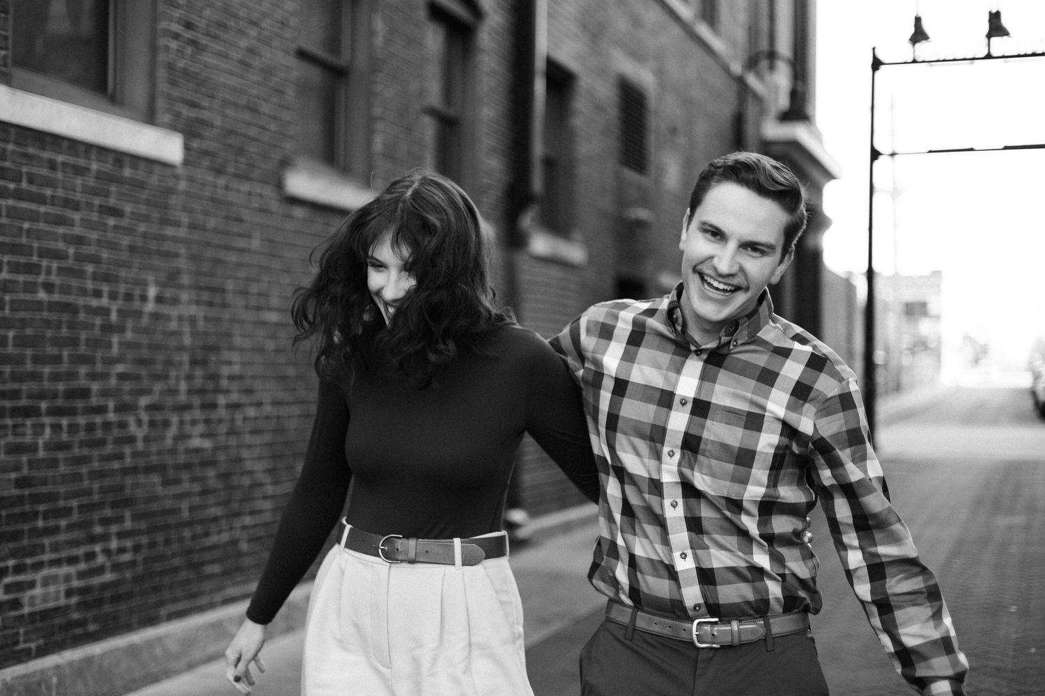 downtown springfield missouri engagement sessions by hotel vandivort, couple smiling and laughing