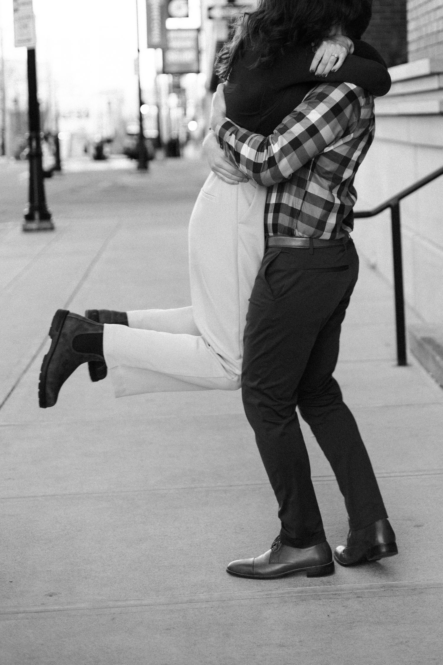 downtown springfield missouri engagement sessions by hotel vandivort, couple spinning around candidly, black and white