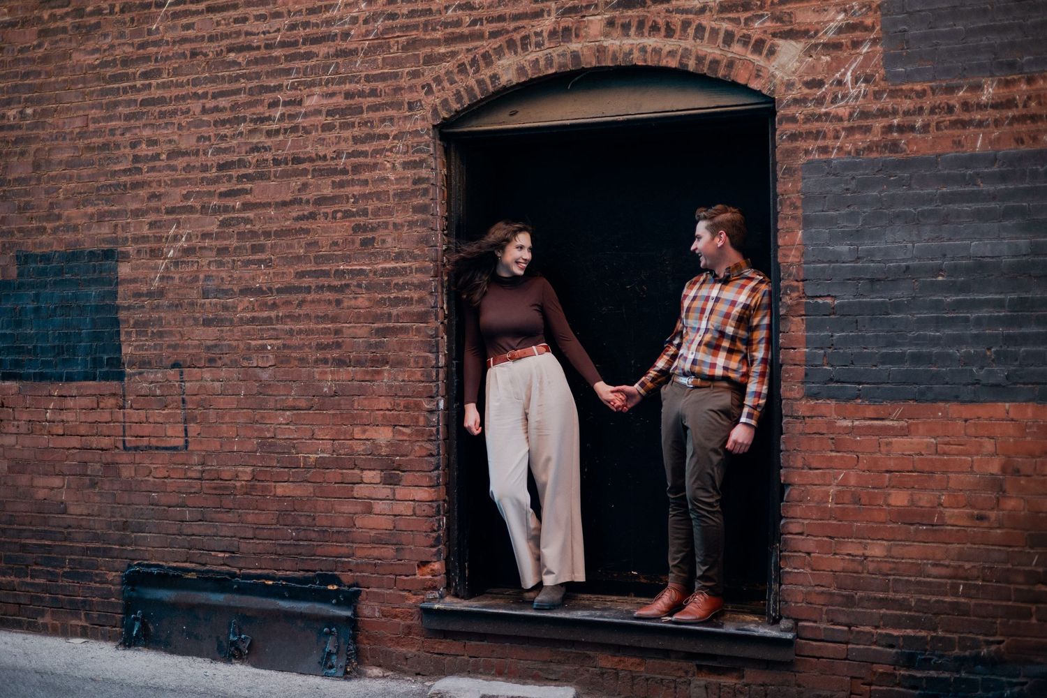 downtown springfield missouri engagement sessions by hotel vandivort, couple smiling at each other candids