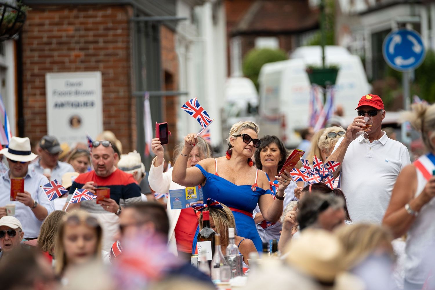 woman holding uk flag at a street party