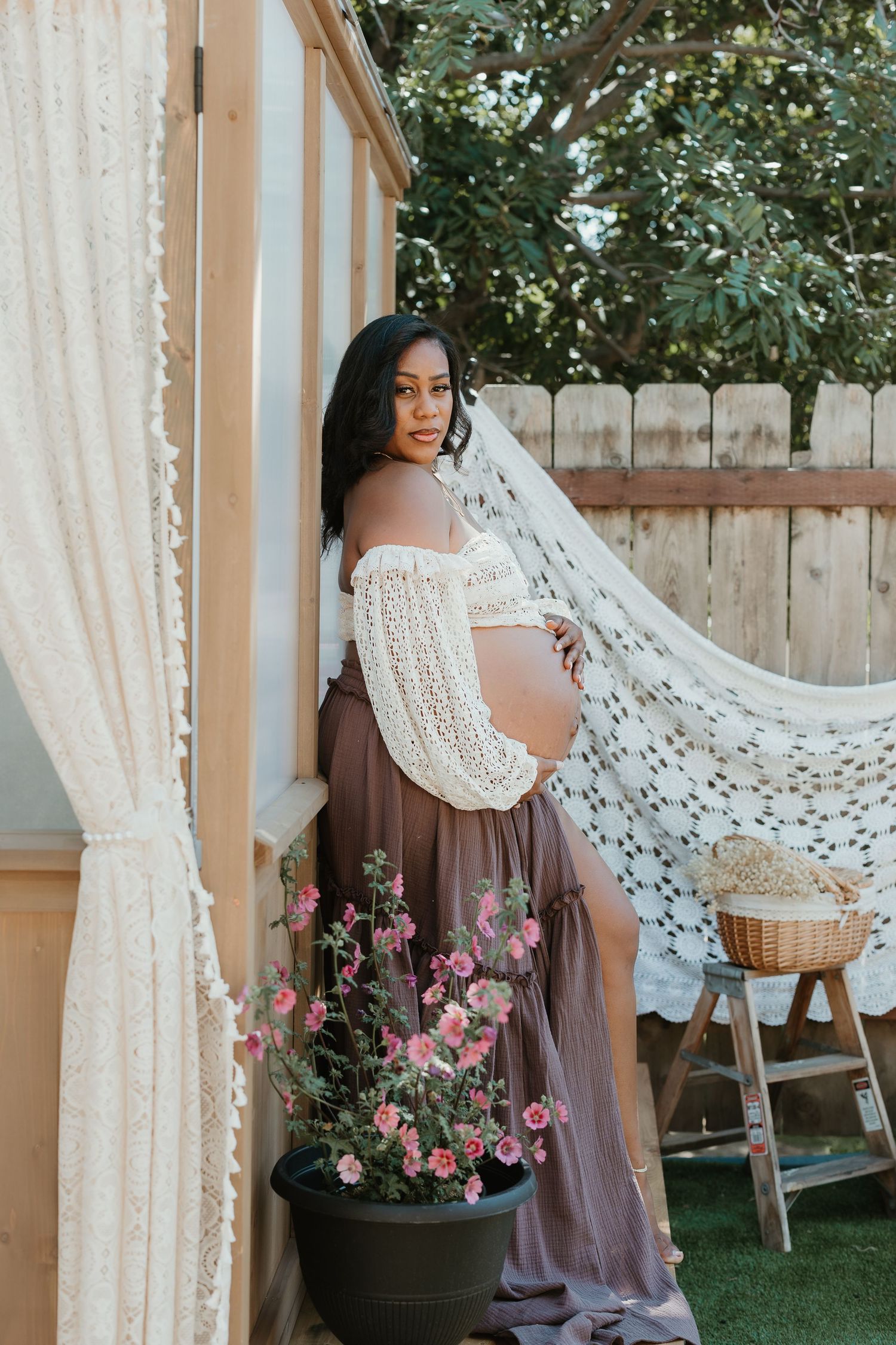 Expecting parents during mountain maternity shoot at Lake Cuyamaca, mom wearing stylish tan hat. San Diego maternity photographer