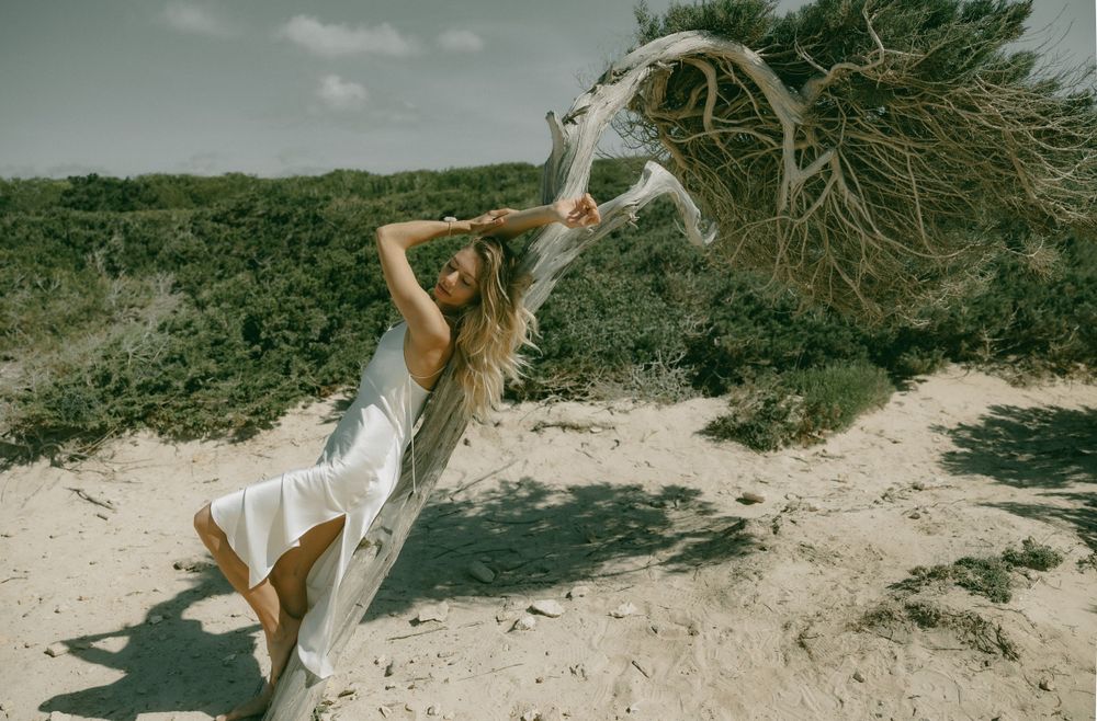 Dynamic movement shot on beach with flowing white dress.