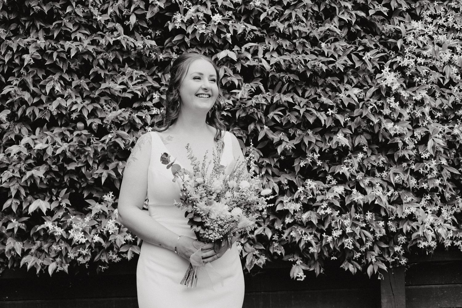 Black and white photo of a bride wearing a white dress, captured by Apertured Media Auckland Wedding Photographer.