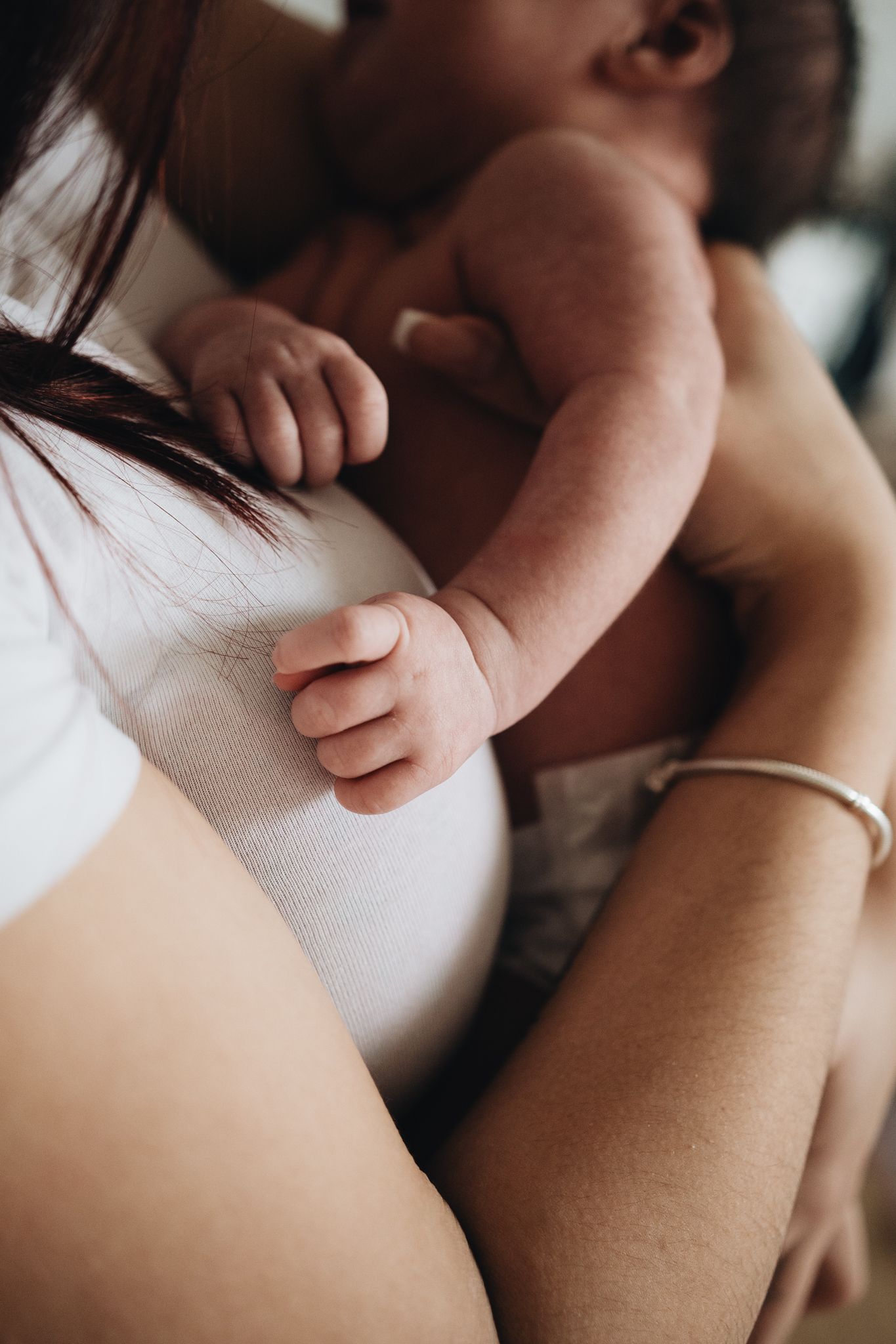 Close-up sequence of hands gently touching and caressing skin in soft natural lighting.