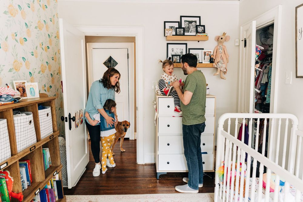A family playing in a nursery with two little daughters in Charlotte, NC.