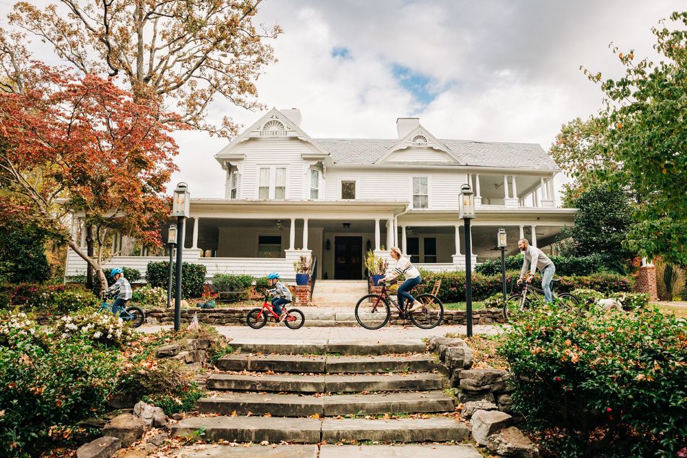 A family rides bikes around their Charlotte family home.