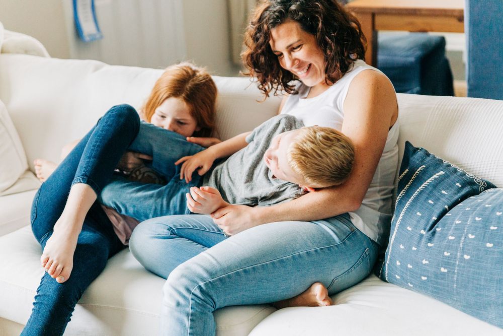 A photo showing people relaxing together on a comfortable couch in their Charlotte home.
