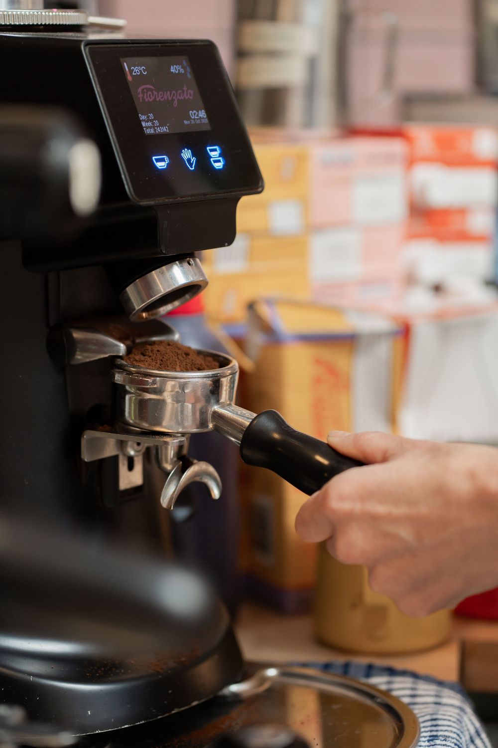 Close-up shots of an espresso machine portafilter being prepared with ground coffee.