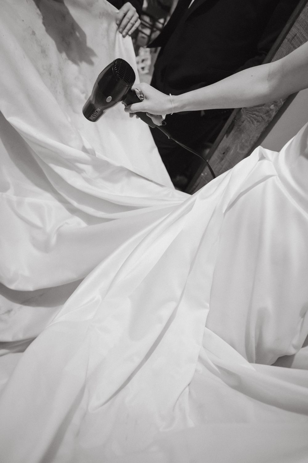 Close-up view of flowing white wedding dress fabric creating elegant folds and textures.