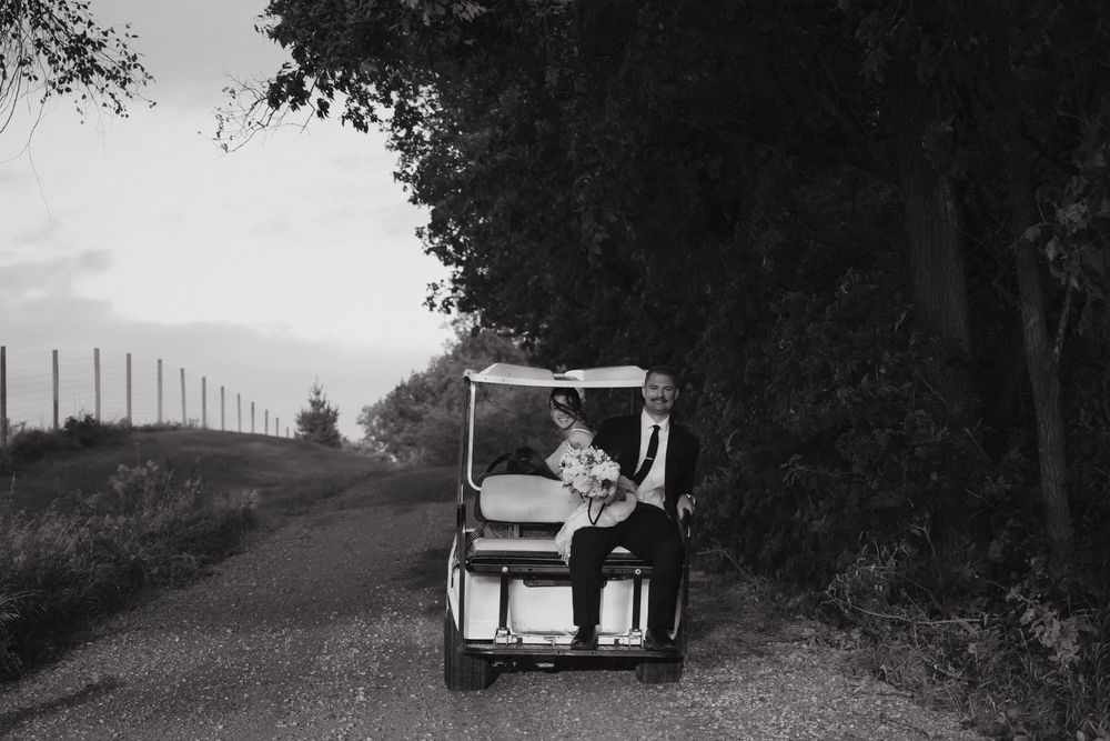 A black and white photo collage showing multiple vintage cars driving down a rural country road.