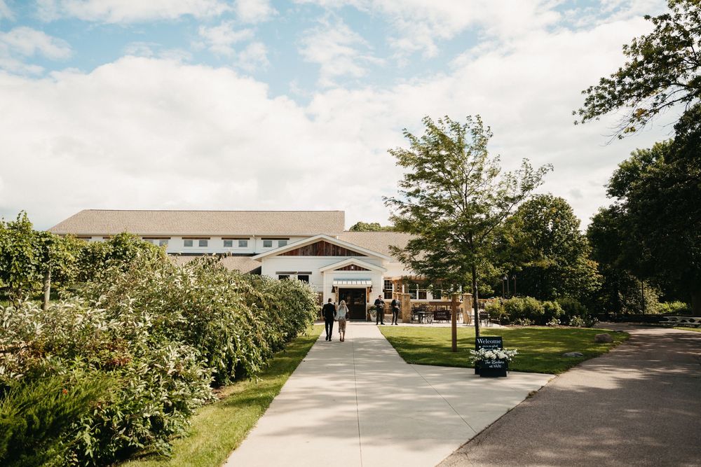 A series of exterior views of a modern school building with landscaped grounds and walkways under a blue sky.