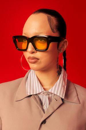 Stylish sunglasses with orange lenses shown in sequence against a bold red backdrop.
