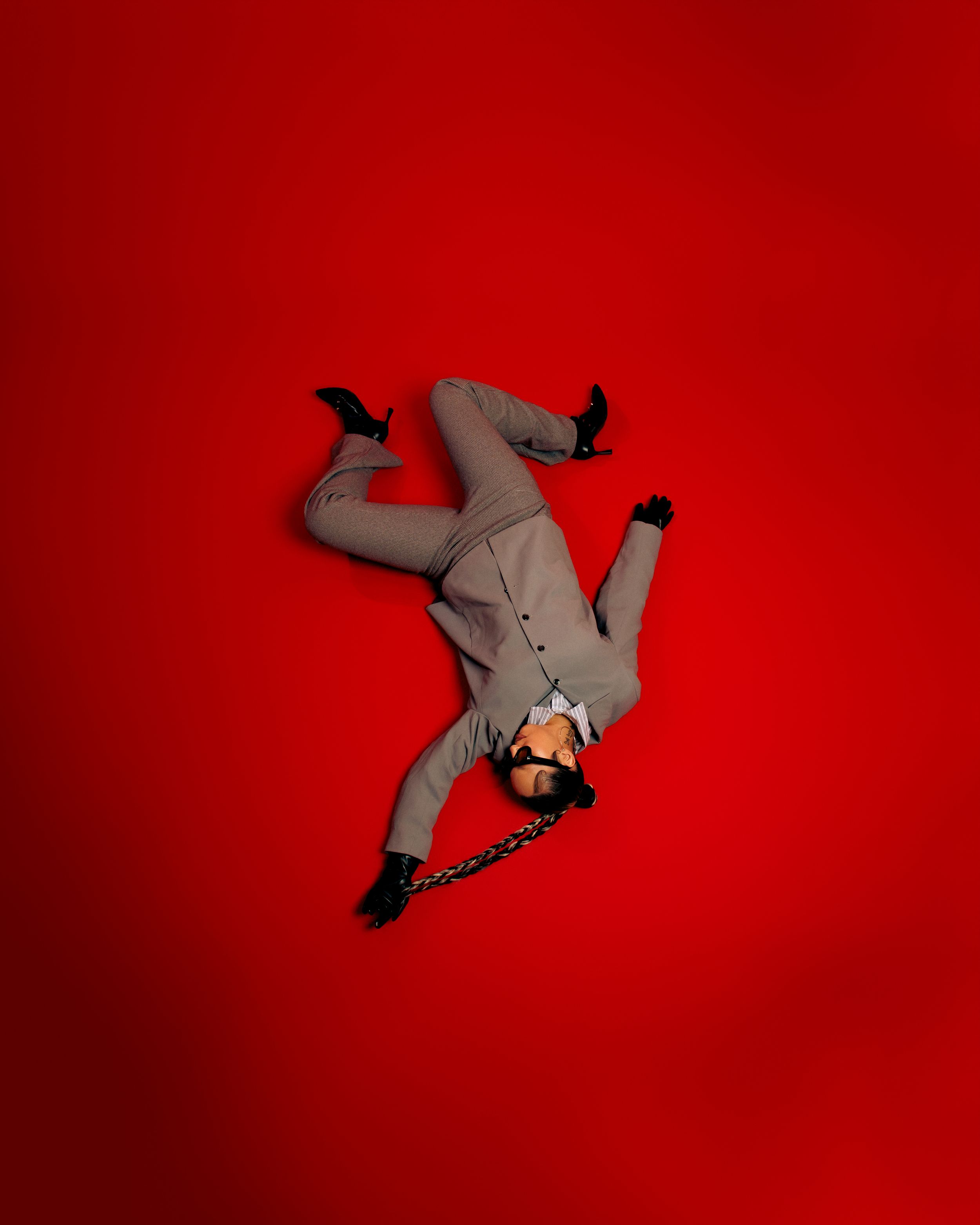 Gray origami shark figures arranged against a vibrant red background in an artistic composition.