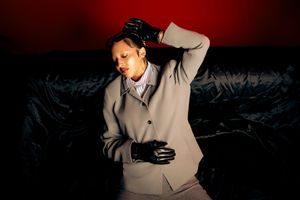 A series of dark cinematic stills showing a person in formal attire against dramatic lighting and shadows.