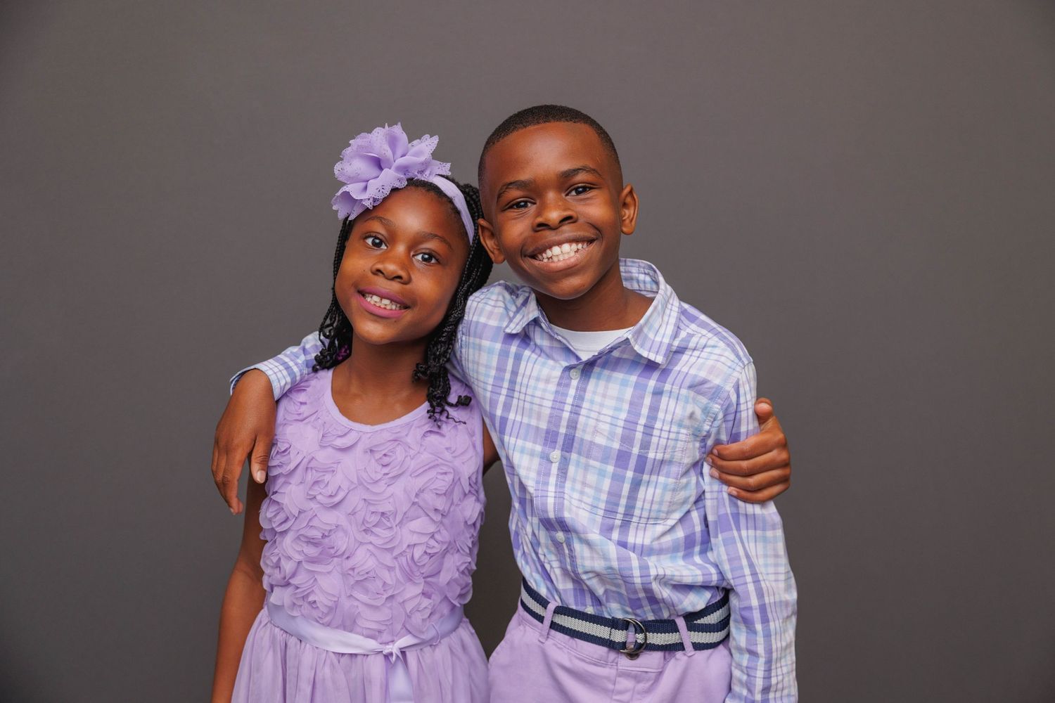 A collection of photos showing a pair in coordinating purple and blue outfits posing together.