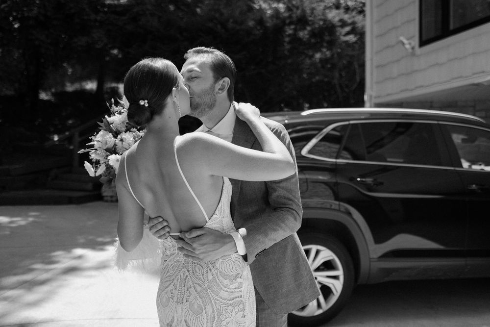 Black and white candid wedding photos showing joyful moments between newlyweds outdoors.
