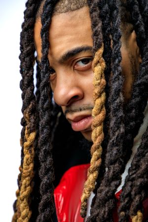 Close-up of distinctive black and blonde dreadlocks against dark background. photography st louis.