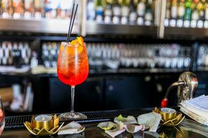 Bar interior with colorful cocktails and bottles displayed on shelves. live event photography st louis.
