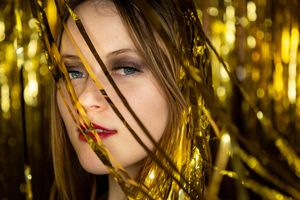 Glamour portrait series with gold bokeh lighting effects and dramatic shadows. live event photography st louis.