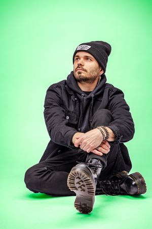 Urban style portraits on green background featuring winter wear and boots. portrait photography st louis.