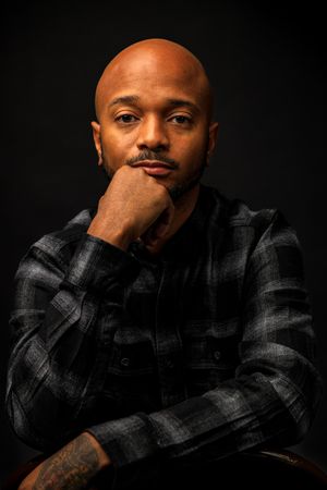 Moody portrait series against black background in plaid shirt.portrait photography st louis.